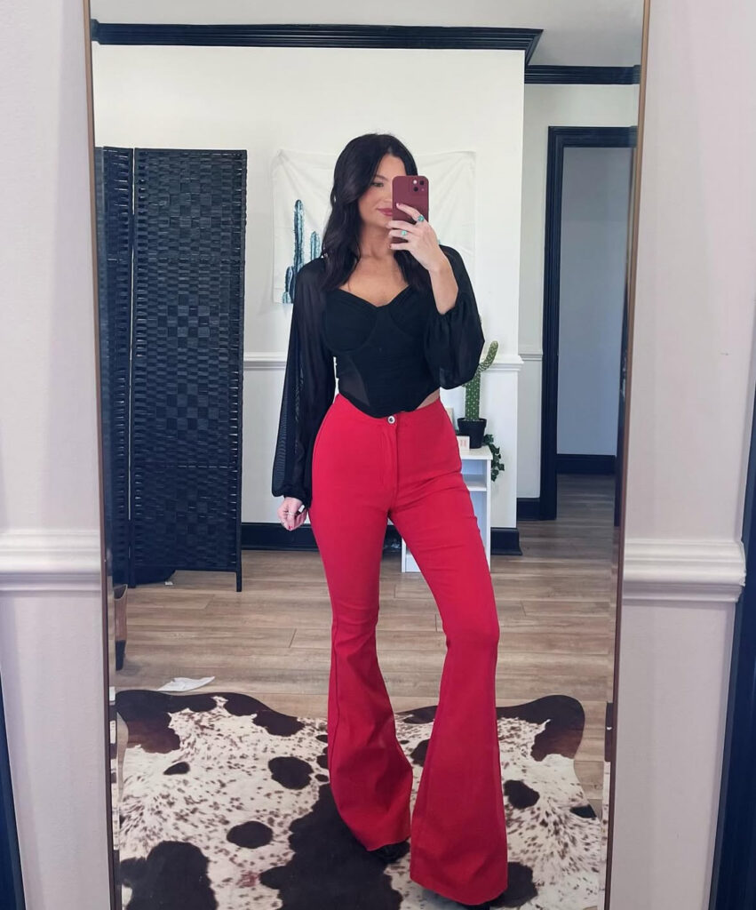 Valentines Day outfit with a fitted black top and bold red flare pants (easy, confident, and date-night ready).