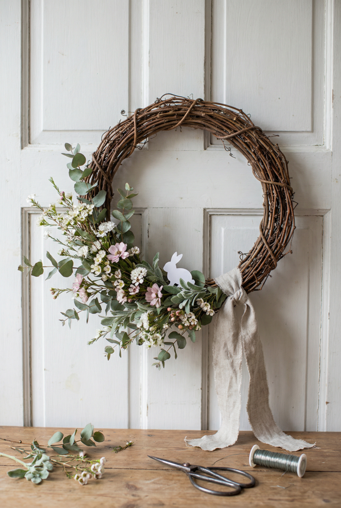 Grapevine wreath with soft greenery, spring floral wreath accents, and a linen ribbon, airy easter wreath ideas for the door