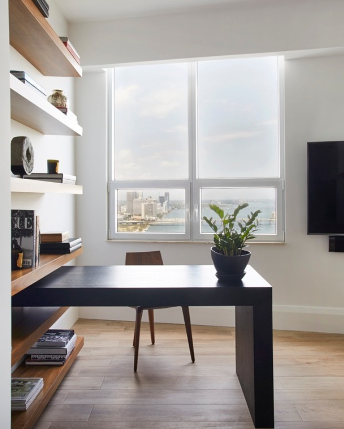 Professional office decor featuring executive office furniture, a statement chandelier, backlit shelving, indoor plant, and modern office styling ideas in a luxe neutral palette.