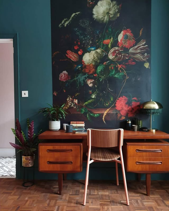 Professional office decor in a warm neutral workspace with wood desk, layered lighting for office ambiance, floating shelves, built-in storage, and a textured rug.