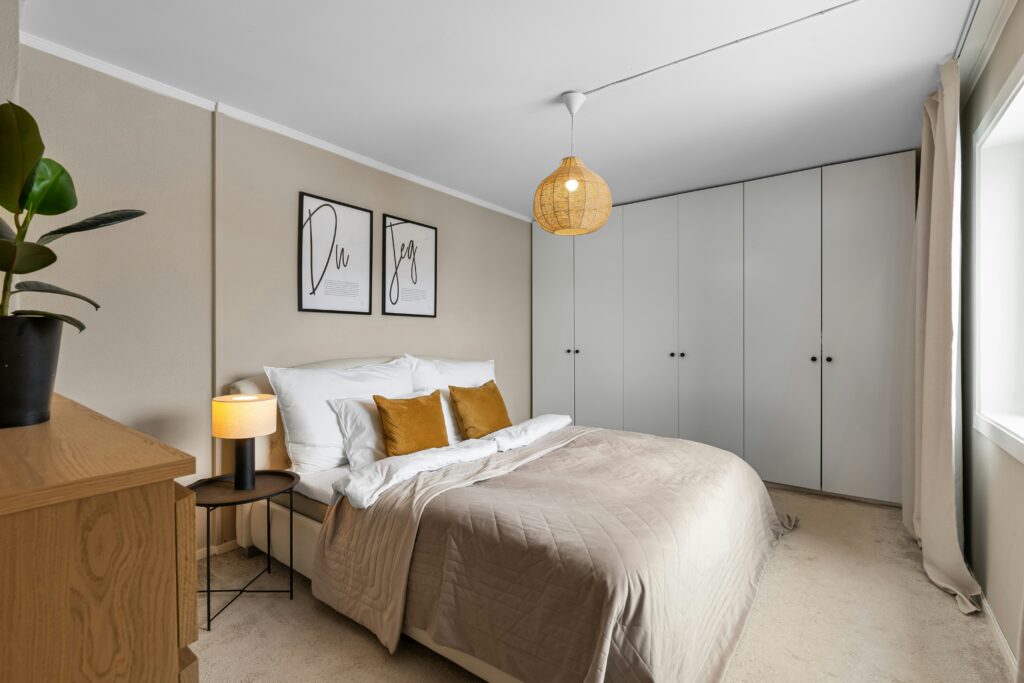 Floor to ceiling built-in wardrobe in master bedroom with grey hinged doors