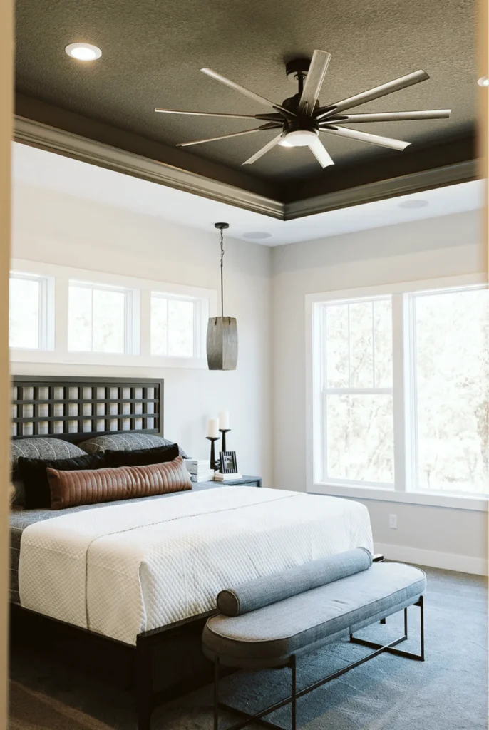 Bedroom with a dark painted tray ceiling, ceiling fan, recessed lights, and modern neutral bedding