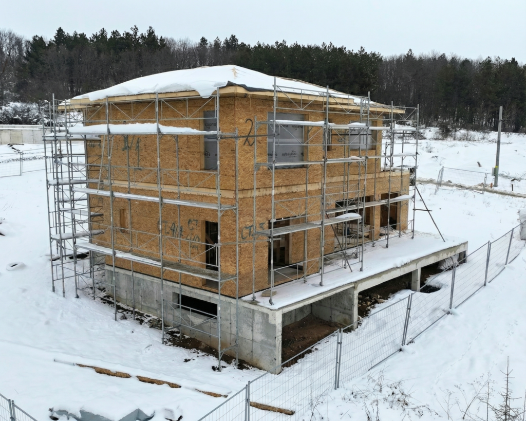 new build house winter construction stage snow roof missing
