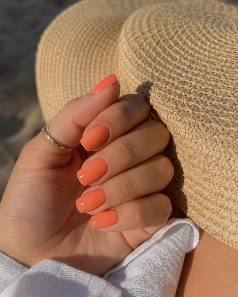 Soft coral pink orange nails on coffin shaped gel manicure
