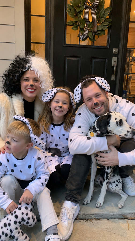 Parents and kids in black-and-white spotted outfits with dog ears, 101 Dalmatians Disney Halloween costume