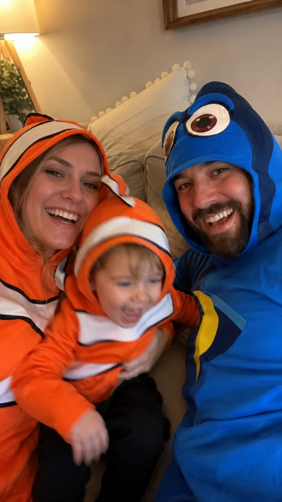 Parent and children in orange-and-white and blue fish costumes, Finding Nemo Disney Halloween costume