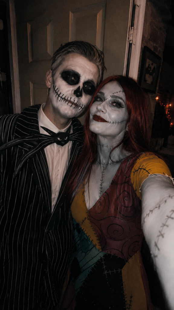 Couple in a pinstripe suit and patchwork dress with spooky makeup, Jack and Sally Disney Halloween costume