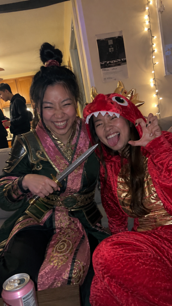 Two friends in green-and-pink armor with a topknot and a little red dragon costume, Mulan and Mushu Disney Halloween costume