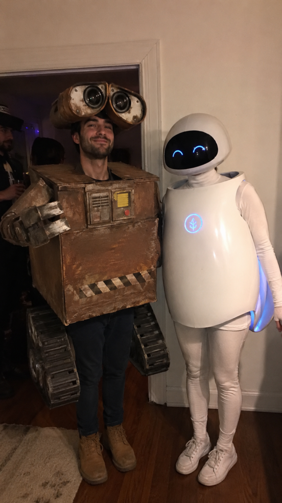 Couple in a rusty boxy robot costume and a sleek white robot costume, Wall-E and Eve Disney Halloween costume