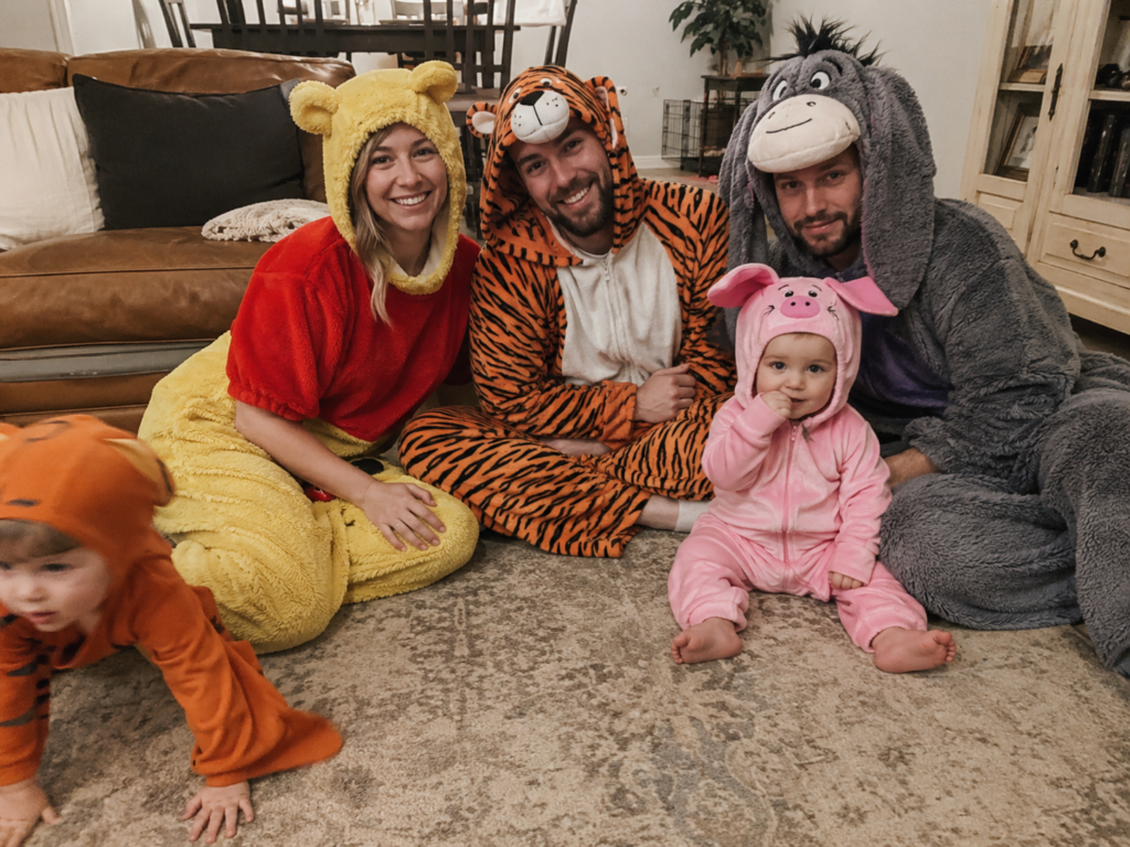Adults and toddlers in fuzzy bear, tiger, donkey, and piglet costumes, Winnie the Pooh Disney Halloween costume