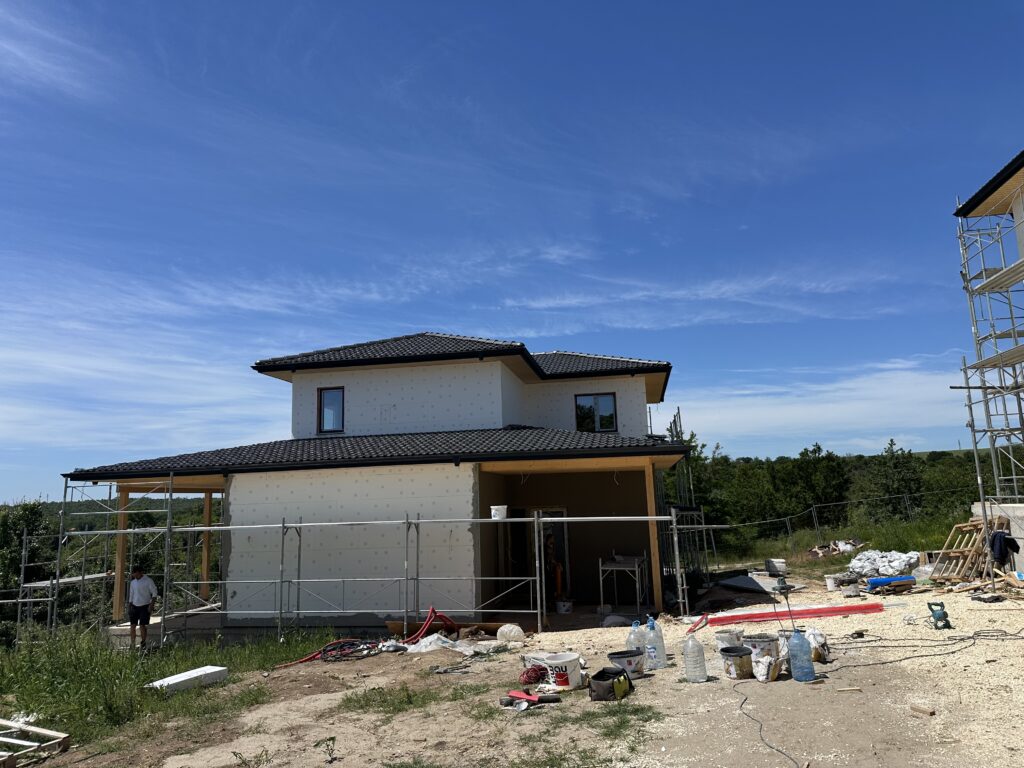 White EPS insulation and scaffolding before the house exterior was finished
